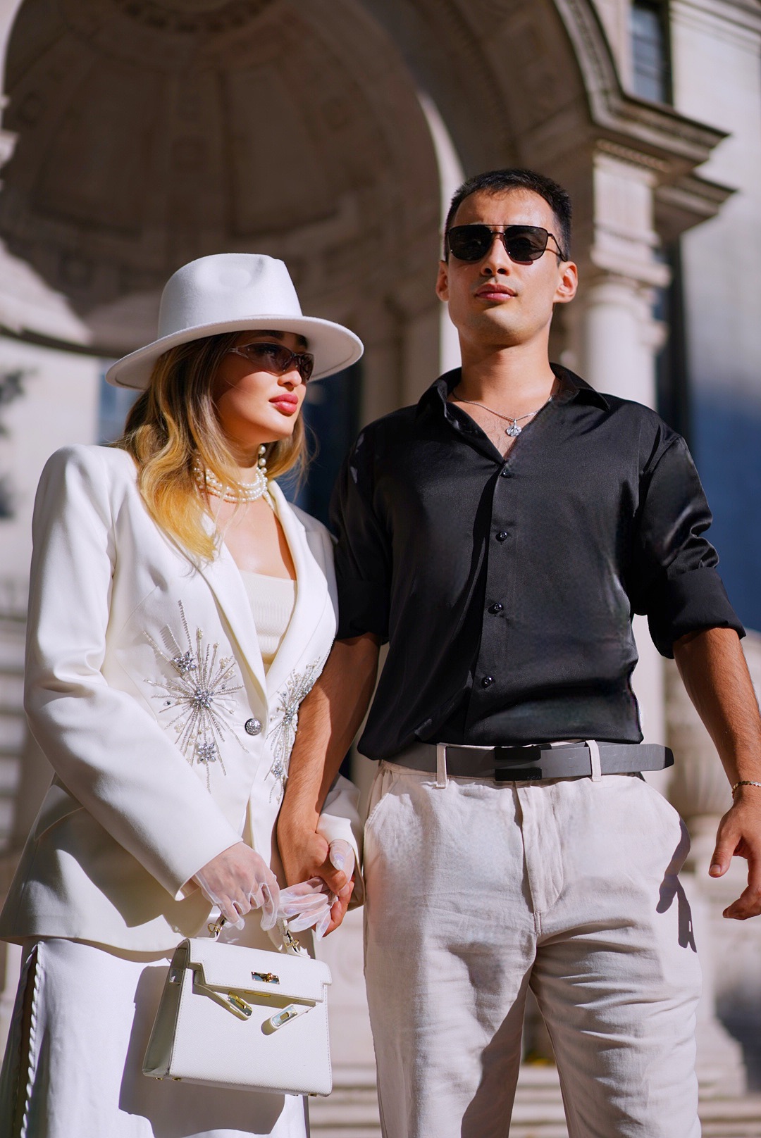 Couple standing together beneath a city arch in New York City
